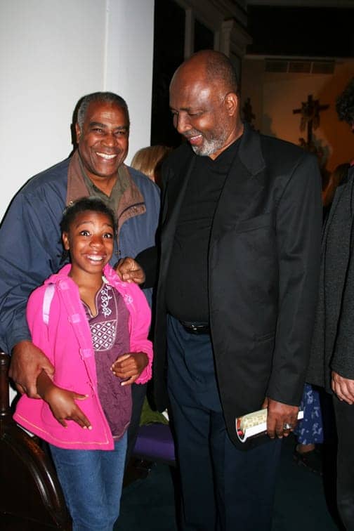 Pierre Labossiere with his daughter Malaika glow in the presence of Father Gerry Jean-Juste when he spoke on Sept. 9, 2006, at St. Joseph the Worker Church in Berkeley. Everyone is invited to return there for his memorial on Saturday, June 27, at 7 p.m. The church is located at 1640 Addison in Berkeley. — Photo: Minister of Information JR