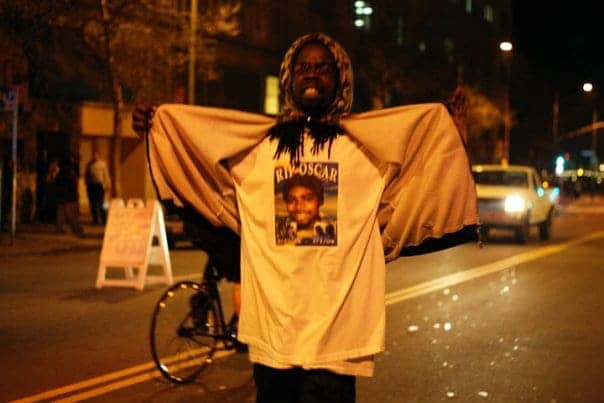 Oscar-Grant-rebellion-youngster-shows-cops-his-OG-t-shirt-010709-by-Malaika1, JR brings Justice for Oscar Grant Campaign to LA Saturday, Local News & Views 