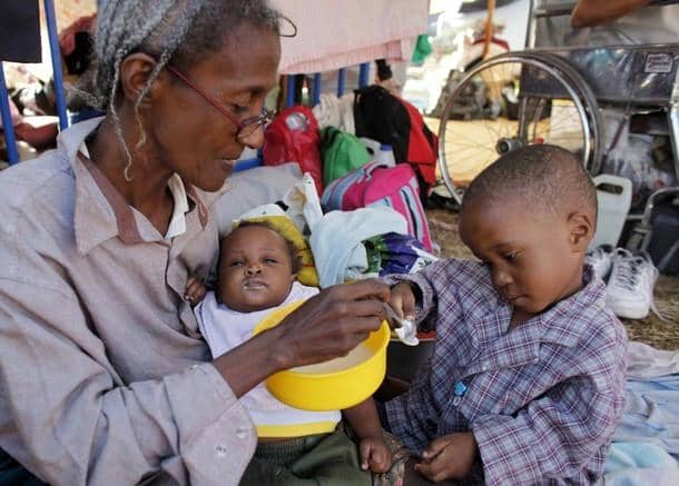 Haiti-earthquake-grandmother-feeds-grandsons-PAP-012110-by-Reuters, On the ground in Port au Prince, World News & Views 