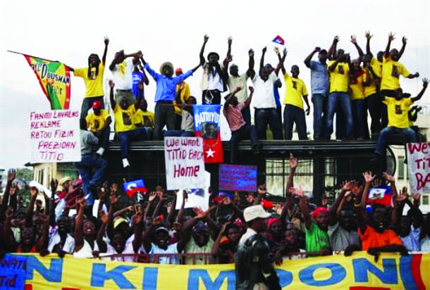 Haitians-demand-Aristides-return-as-Ban-Ki-moon-Bill-Clinton-meet-Preval-PAP-030909-AP, Haiti’s largest political party banned from election process, World News & Views 