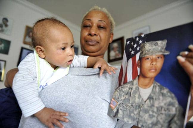 Alexis-Hutchinson’s-mom-Angelique-Hughes-holds-Kamani-pic-of-Alexis-111709-by-Russel-A.-Daniels-AP, Army to discharge single mom rather than court-martial her, News & Views 