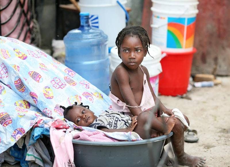 Haiti-earthquake-little-girl-baby-sister-in-makeshift-camp-PAP-020510-by-Ben-Gurr-The-Times, The myth of the orphan – from Haiti to Hayward, World News & Views 