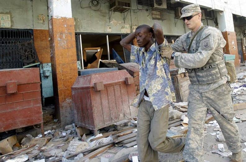 Haiti-earthquake-Marine-arrests-looter-0110-by-Felix-Evens-Reuters, Just what Haiti doesn't need: Rwandan police, World News & Views 