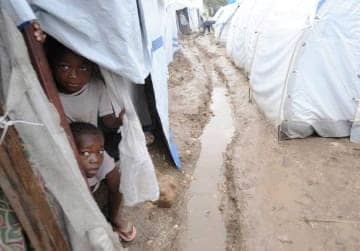 Haiti-earthquake-children-peer-out-of-tent-at-rain-031910-PAP-by-AFP-Getty-Images1, Joint report issued on conditions in Haiti’s displaced persons camps, World News & Views 