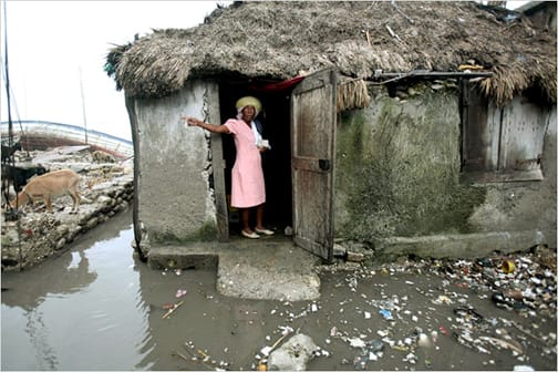 haiti-les-cayes-woman-goats-home-flooded, Haiti policy statement for President Obama and Congress, World News & Views 